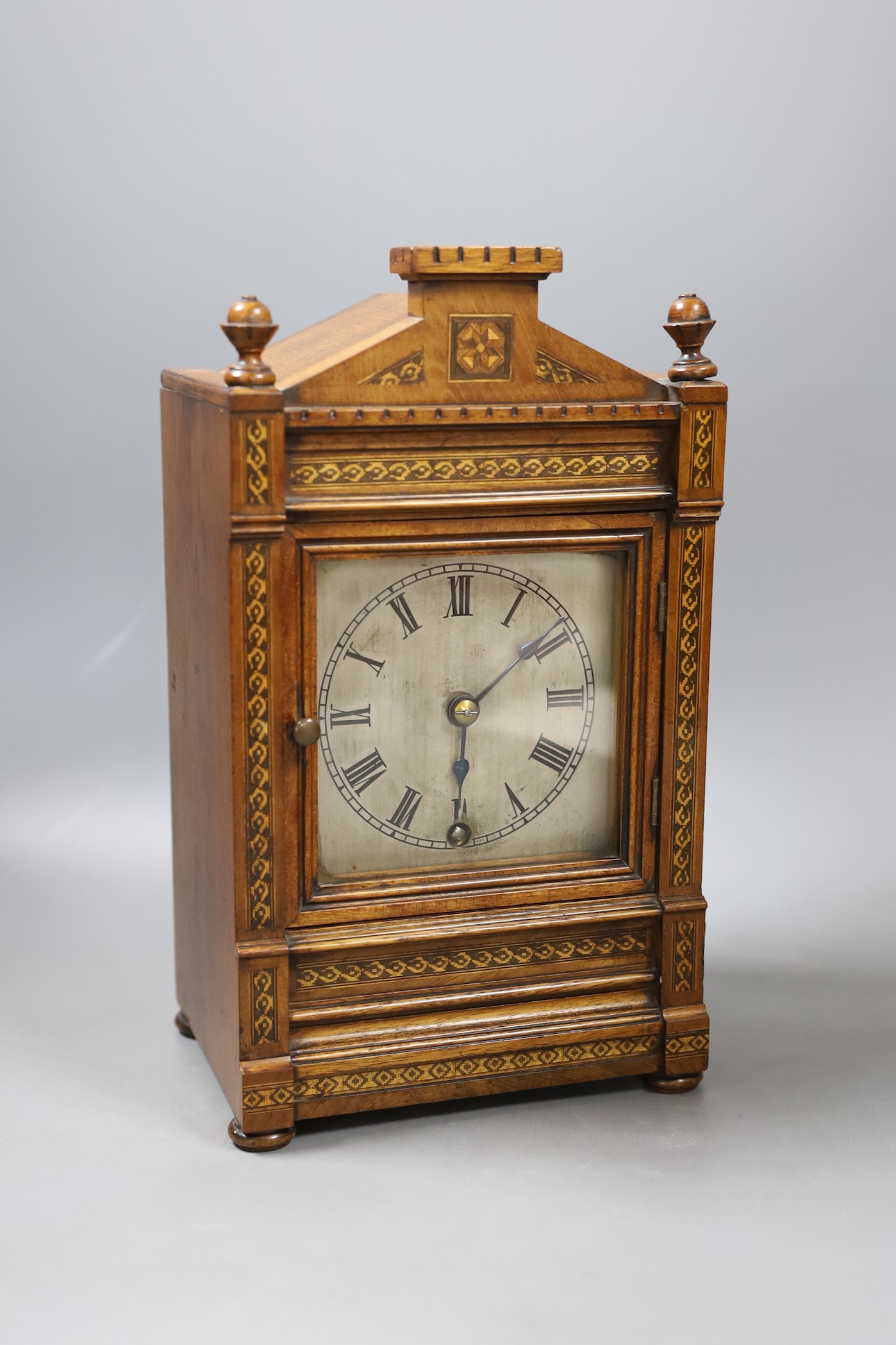 A late 19th century mantel clock in a walnut and Tunbridgeware banded case
